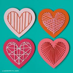 three heart shaped paper crafts on a blue background