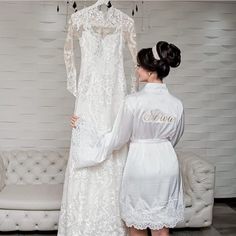 two women in white robes standing next to each other, one wearing a wedding dress