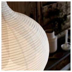 a large white vase sitting on top of a table