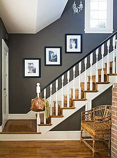 a staircase with pictures on the wall next to it