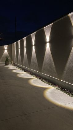 an outdoor wall with lights on it at night