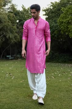 Rani pink full sleeve kurta with mirror, thread embroidery in stripe pattern. Paired with ivory salwar. Components: 2 Pattern: Embroidery Type Of Work: Mirror, thread Neckline: Mandarin collar Sleeve Type: Full sleeves Fabric: Georgette, Lining: Cotton Color: Pink Other Details:  Front button detailing Side slit kurta Occasion: Sangeet - Aza Fashions Traditional Indian Mens Clothing, Indian Wedding Suits Men, Stylish Boy Clothes, Wedding Kurta For Men, Embroidery Mirror, Haldi Outfits, Wedding Dresses Men Indian, Sangeet Outfit