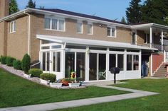 a large house with many windows in the front yard