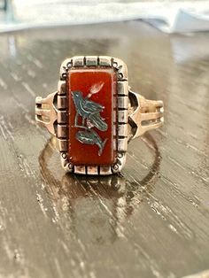 Victorian ring 10K rectangular Carnelian With silver in laid bird, saddle back smooth setting, wonderful designed shoulder, nice framing to the setting.  Condition good for its age any wear commensurate with age, pictures show the details.  Size 7, approx. 1/2" north to south on finger, wt.- 1.6grams delicate and enchanting. Victorian Ring, Victorian Rings, Rings Statement, Picture Show, Halloween Shopping, Saddle, Statement Rings, Jewelry Accessories, Jewelry Rings