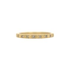 a yellow gold ring with five diamonds on the inside and outside, set against a white background