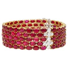 18K yellow gold multi row link tennis bracelet, weighing 45.36 grams. Featuring an astounding 72.51 Carats of natural oval cut rubies, a breathtaking total of 128 stones, each radiating a deep and alluring red hue, meticulously prong-set in yellow gold to capture their exquisite beauty. Paired with 1.78 Carats of bezel set round cut diamonds, a total of 27 stones. 5 rows of oval cut rubies and round cut diamonds. All natural mined gemstones and set in 18k solid gold. A luxury tennis bracelet wit Luxury Gold Oval Link Tennis Bracelet, 18k Gold Bracelet, Bracelet Tennis, Ruby Bracelet, White Gold Solitaire, Gold Armband, Diamond Jewelry Designs, Expensive Jewelry, European Cut Diamonds