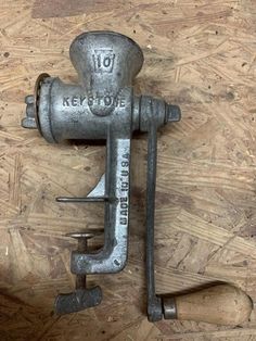 an old metal lever on top of a wooden floor