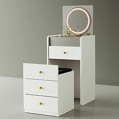 a white vanity with two drawers and a mirror