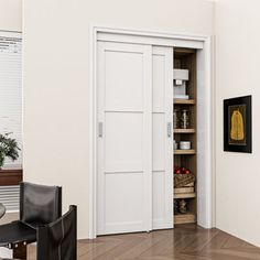 an empty room with a chair, table and open door to the dining room area