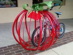 a red bike that is sitting on the sidewalk