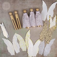 paper flowers and wooden pegs on a table