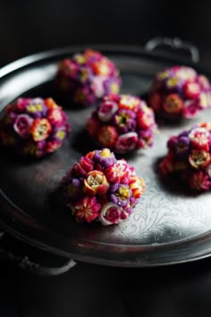 there are many small flowers on the tray