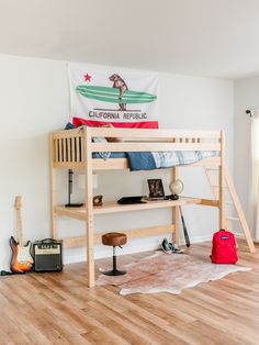 a bunk bed sitting on top of a hard wood floor next to a red bag