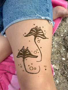 a woman's leg with a tattoo on it that has an image of a sea horse