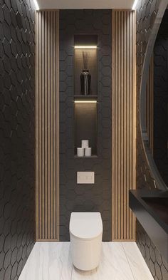 a modern bathroom with black and gold accents on the walls, along with a white toilet