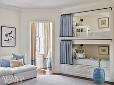 a living room with bunk beds and blue curtains