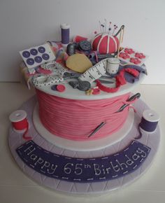 a birthday cake decorated with sewing related items