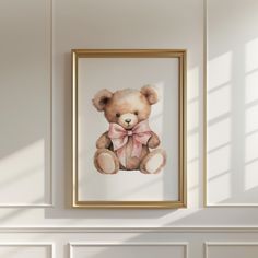 a painting of a teddy bear with a pink bow on it's head hangs above a white wall