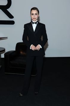 a woman in a tuxedo poses for the camera