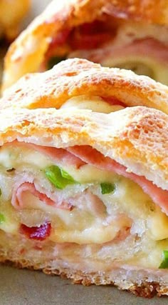 a close up of a sandwich with ham and cheese on it's crusts