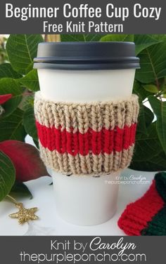 a knitted coffee cup cozy sitting on top of a white table next to green leaves