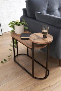 a living room with a gray couch and wooden table on the floor next to it