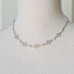 This necklace features beautiful rhinestones and ivory glass pearls . The necklace is reminiscent of the classic Regency designs of the past. It hangs about 16 1/4" long from a stainless steel chain with lobster clasp and 2" extender chain that are nickel free.   Comes in a lovely gift box with ribbon.  In the Eighteenth and Nineteenth centuries necklaces and earrings were very fashionable. Some were made of pearls, glass or gemstones and can be seen in many classic portraits. I think they're a Elegant Rhinestone Necklace For Vintage Events, Vintage Silver Bridal Necklace With Pearl Chain, Vintage Silver Pearl Bridal Necklace, Vintage Pearl Bridal Necklace In Silver, Victorian Pearl Charm Necklace For Wedding, Vintage Crystal Pearl Necklace For Wedding, Vintage Pearl Necklace With Crystal For Wedding, Vintage Pearl Necklaces With Rhinestones, Vintage Silver Bridal Necklace With Pearl Drop