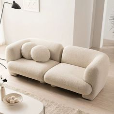 a white couch sitting on top of a hard wood floor