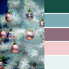 a christmas tree with ornaments hanging from it's branches and the colors are blue, pink