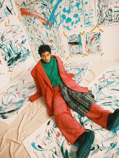 a man sitting on top of a bed covered in graffiti