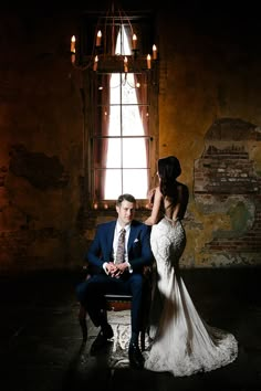 a bride and groom sitting in front of a window