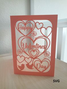 a valentine's day card with hearts cut out of paper