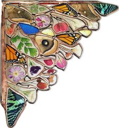 a colorful butterfly brooch sitting on top of a wooden frame