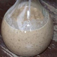 a glass bottle filled with liquid sitting on top of a table