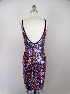 "This fun vintage party dress! It is fully embellished with rainbow paillette sequins and in excellent condition! Size SMALL Measurements: Bust - 32\" Waist - 26\" Hips - 36\" Length - 34\" Tag Size - 4 / Small (please refer to measurements) Size MEDIUM Measurements: Bust - 34\" Waist - 28\" Hips - 38\" Length - 33\" Tag Size - 6 /Medium (please refer to measurements) This dress comes from a pet-free and smoke-free home. If you would like more info or have any questions, please don't hesitate to Fitted Sequin Dress For Carnival, Sequin Dress For Carnival Costume Party, Sequin Dress For Costume Party And Carnival, Disco Style Embellished Sequin Cocktail Dress, Glamorous Sequin Party Dress For Carnival, Glamorous Sequined Dress For Carnival, Glamorous Multicolor Sequin Cocktail Dress, Glamorous Multicolor Sequin Fabric For Party, Embellished Party Dresses For Carnival