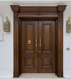 the front door to a house with two large wooden doors