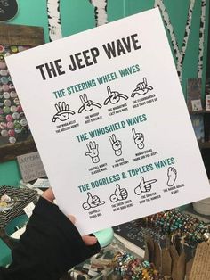 a person holding up a sign with instructions on how to use the jeep wave