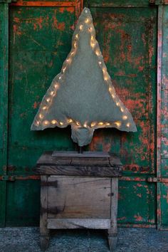 an old wooden chest with a light up triangle shaped mirror on it's side