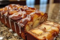 a loaf of cinnamon bread with icing on it sitting on top of a counter