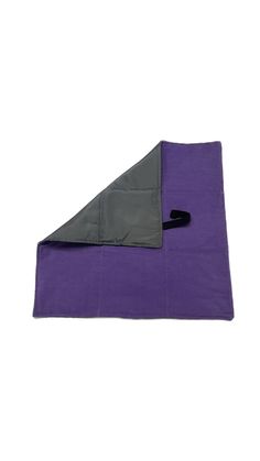 the purple and grey blanket is folded up