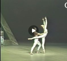 two dancers in white are performing on stage