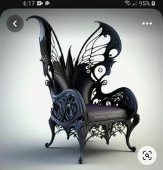 a black butterfly chair sitting on top of a white floor next to a phone screen