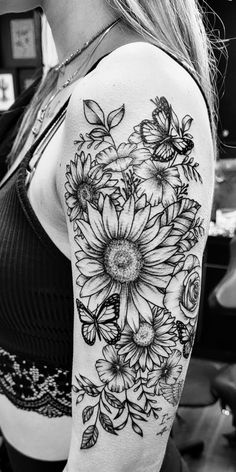 black and white photo of a woman's arm with sunflowers on it