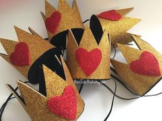 several crowns with red hearts on them are sitting on a white surface and ready to be used as decorations