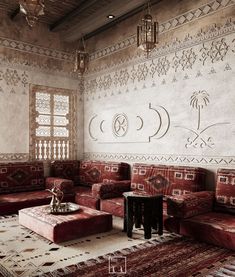 a living room with red couches and rugs