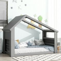 a child's bed in the shape of a house