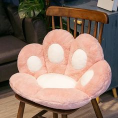 a pink chair with paw prints on it