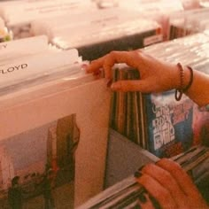 a woman is looking at records in a record store with the words i'm in love with your soul and everything that you are