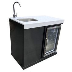 a black and white kitchen sink with an ice chest underneath the faucet,