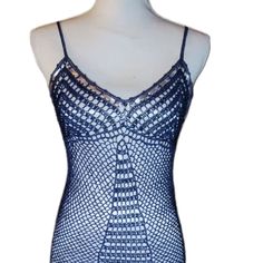 a mannequin wearing a blue and white top with an openwork design on it